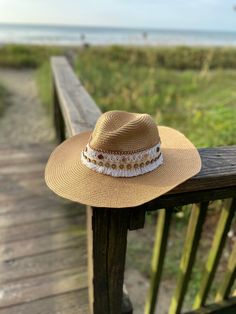 Decorated straw hat, fits size medium to small. Our Blanca Azucena hat is a beautiful and comfortable must have for any occasion. It's decorated with white lace, brown button trim and camel suede trim. Each hat is 100% made by hand and made by daily inspirations. No two hats are the same. Gold Straw Brimmed Hat, Gold Brimmed Straw Hat, Gold Straw Hat With Curved Brim For Vacation, Gold Curved Brim Straw Hat For Vacation, Adjustable Gold Panama Hat With Wide Brim, Gold Adjustable Fedora Panama Hat, Gold Panama Fedora Hat With Adjustable Fit, Adjustable Gold Fedora Panama Hat, Gold Flat Brim Hat For The Beach