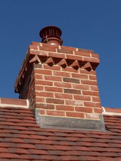 a red brick chimney on top of a roof