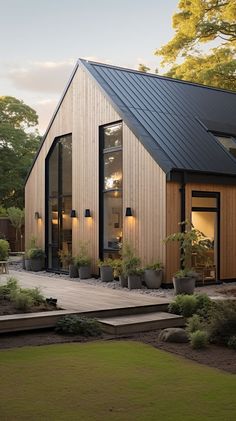 a modern house with wooden siding and black roof