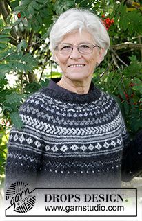 an older woman wearing glasses standing in front of a tree with berries on it and the caption drops design