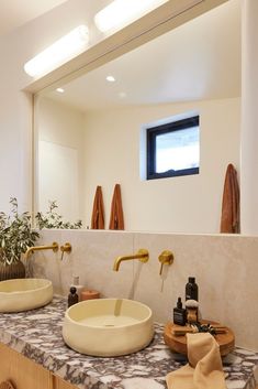 a bathroom with two sinks and mirrors in it