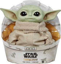 the child yoda toy is in a plastic container