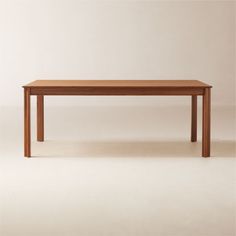 a wooden table sitting on top of a white floor