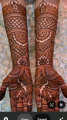 two hands with henna designs on them