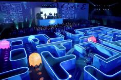 a large maze in the middle of a room filled with blue and pink light up items