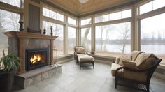 a living room filled with furniture and a fire place in front of a large window