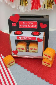 an open toaster oven with hearts and faces on the inside, sitting on a table