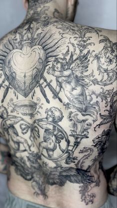 the back of a man with tattoos on his chest