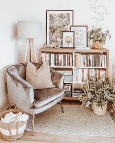 a living room filled with furniture and bookshelves next to a lamp on a table