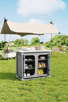 an outdoor kitchen is set up in the grass