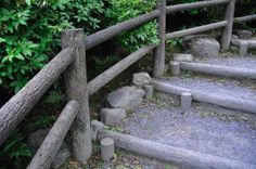 the steps are made from wood and have rocks on each side, along with stones in between them