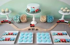 a train themed birthday party with cupcakes and cake