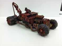 a toy car made out of scrap metal and rusted to look like an old tractor