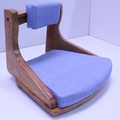 a wooden chair with blue fabric on it