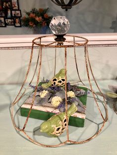 a decorative bird cage with flowers in it