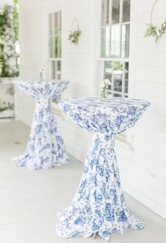 two blue and white pedestals sitting on the side of a building