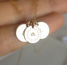 "Dainty, sweet and so very pretty! You can place the initials of all your darling sunshines on one delicate 14k gold fill necklace. Each disc is approximately 9mm in diameter and is made of 14k gold fill. A tiny initial will be engraved in the center of the disc which is uniquely embellished with a sun ray pattern. A 14k gold fill spring ring clasp is provided for easy opening and closing. Please don't forget to let me know what initial(s) you would like to have engraved in the \"note to seller\ Cute Gold Jewelry For Anniversary, Dainty Stamped Charm Necklaces For Anniversary, Dainty Stamped Charm Necklace For Anniversary, Dainty 14k Gold Charm Necklace For Anniversary, Dainty Stamped Necklace For Anniversary, Cute Gold Charm Necklaces For Personalized Gifts, Cute Gold Charm Necklace For Personalized Gift, Cute Personalized Yellow Gold Jewelry, Personalized Cute Yellow Gold Jewelry