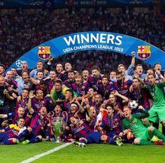 the barcelona team celebrate with the trophy