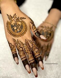 a woman's hands with hennap on it and some designs on her hand