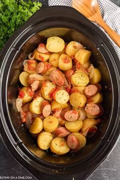 the crock pot sausage and potatoes is ready to be cooked in the slow cooker