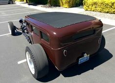 an antique car is parked in a parking lot