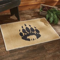 a door mat with an image of a bear's paw and pine cones on it