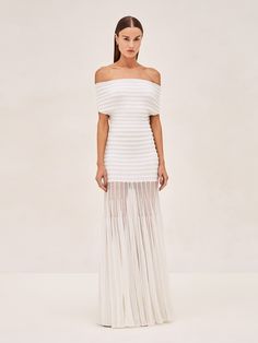 The Marce Dress is a testament to timeless style, featuring a striking off-the-shoulder neckline that seamlessly transitions into an elegant, pleated skirt. The crisp white hue enhances its sleek silhouette, making it a perfect canvas for accessorizing or keeping it minimalist. Pearl Off Shoulder Dresses, Sheer Overlay Dress Wedding, Sheer Bottom Wedding Dress, Wedding Shower Looks, White Dress For Proposal, Mexico Rehearsal Dinner Outfit, Smocked Wedding Dress, Chic Bridal Shower Outfits, Colorful Rehearsal Dinner Dress