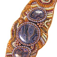 beaded brooch with beads and stones on it