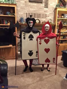 two people in costumes holding playing cards