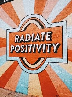 a sign that reads radiate positivity on the side of a building