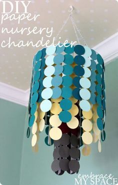 a chandelier made out of paper circles hanging from the ceiling