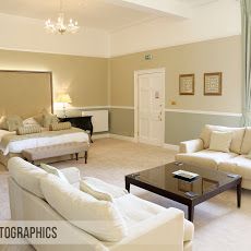 a living room filled with furniture and a chandelier