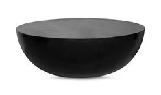 a black round table sitting on top of a white floor