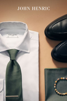 Flat shot showing a white shirt, a bracelet and green accessories from John Henric. Pink Bow Tie, Blue Beaded Bracelets, Wool Tie