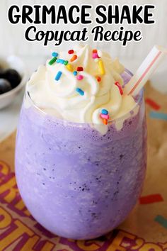 a purple drink with whipped cream and sprinkles