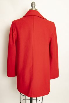 "Vintage 1980s coat of bright red warm wool. Long sleeves with button belt band cuffs. Collared, buttons up front. sleek silhouette flares out a bit. Side hip pockets. Built in padding at shoulders. Fully lined in red satin Label: Fashionfila Fits like size: Small Measurements: Bust: 36\" Waist: 38\" Length: 29\" Shoulder to shoulder: 17\" Sleeve length: 23\" Condition: Excellent. Please do not hesitate to convo with any questions. We upload large pictures - Simply click on each picture for a cl Red Double-breasted Wool Outerwear, Classic Red Wool Coat, Red Spring Outerwear With Button Cuffs, Red Wool Double-breasted Outerwear, Classic Red Long Wool Coat, Red Wool Outerwear For Spring, Red Winter Formal Pea Coat, Red Formal Winter Pea Coat, Red Wool Outerwear With Button Closure