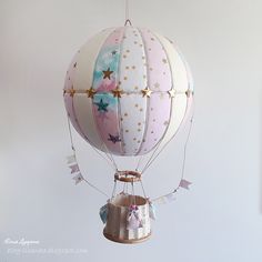 a pink and white hot air balloon with stars on it