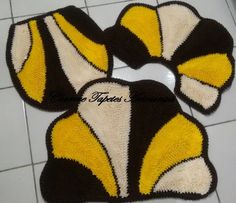 two yellow and black rugs sitting on top of a tile floor next to each other