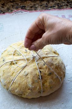 a person pulling string from a loaf of bread