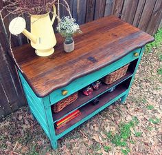 a wooden table with baskets on it and a yellow watering can sitting on top of it