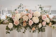 the table is set with white and pink flowers