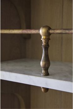 a close up of a metal handle on a shelf