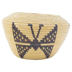 a woven basket with a butterfly design on it