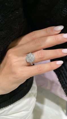 a woman's hand with a diamond ring on it