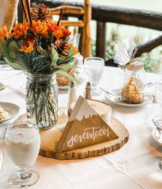 the table is set with flowers and plates