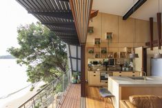 an open kitchen and living room area overlooking the water