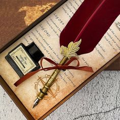 a pen, inkwell and quill sitting on top of an old paper with a map in the background