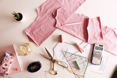 sewing supplies laid out on a table with scissors, paper and other items to sew