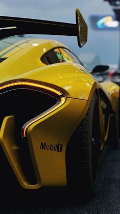 the front end of a yellow sports car