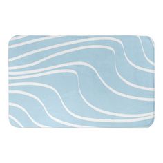 a blue and white bath mat with wavy lines on the front, along with a light blue background